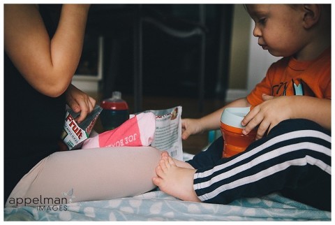 naperville child photographer, color photograph of young children sharing a snack, one child's foot touching the other kid's leg, lifestyle photography, photojournalism, photojournalistic