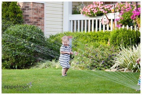 Naperville Child Photographer, Naperville Lifestyle Photographer, child portrait, kid portraits, child photo, kid photos, naperville photographer, oak park, IL, chicago, aurora IL, plainfield IL, family photographer, family portraits, sprinkler, color, toddlers, standing in the sprinkler