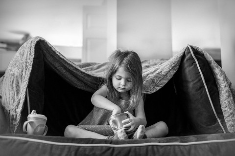 Photograph of child in blanket fort. Naperville Family Photography, naperville child photographer, storytelling photograph, photojournalistic, candid