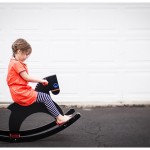 Naperville Child Portraits in Lifestyle photojournalistic art in pictures little girl in orange on rocking horse at home 115-365 2014