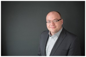 Professional headshot for gentleman in business casual suit grey on grey with glasses in naperville studio