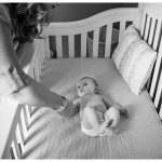 Naperville and Chicago Photographer for families and children mama and little girl holding hands at crib