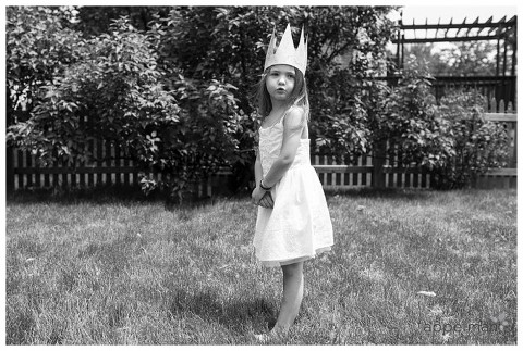 Tiny girl in white dress and handmade crown for film look frozen shoot