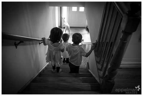 Three little children walking down the stairs in Home Photography session by Naperville Photographer