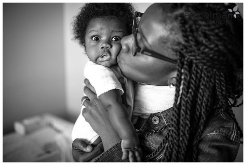 Mama and her baby surprised kiss naperville candid photojournalistic photographer