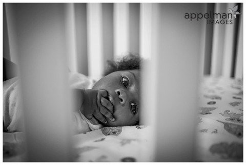 Sweet baby in her crib naperville family photographer lifestyle photojournalism