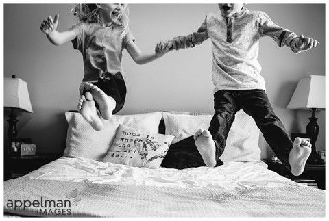 Oswego lifestyle photographer family kids jumping on the bed