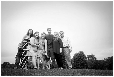 fun family portrait all family squeeze outside in black and white naperville illinois