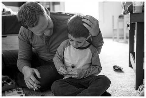 Dad connecting with young son in black and white by family photographer