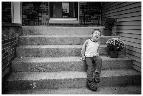 little boy on front porch steps by naperville family photographer