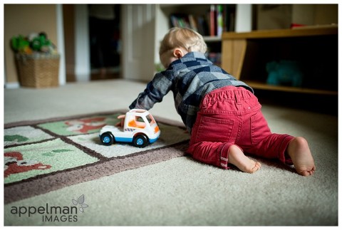 little guy in red pants crawling lifestyle photo
