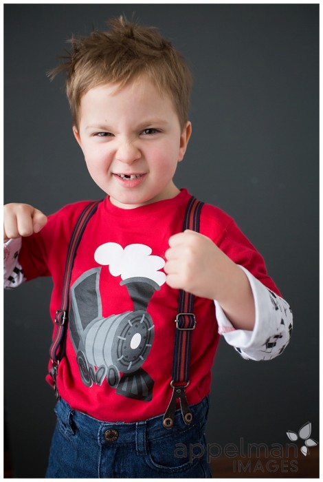 tough guy four years old in red shirt and suspenders